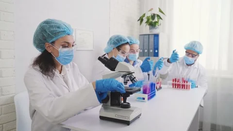 Laboratory assistants with microscope, laboratory assistant with test tubes Stock Footage 230242807