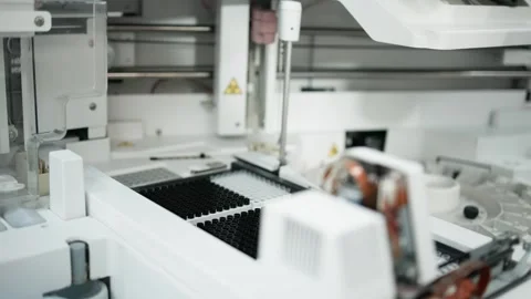 Laboratory automation system with robotic arm transferring sample plates in a Stock Footage 334884738
