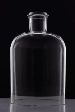 Laboratory bottle without a bottom on black background Stock Photos