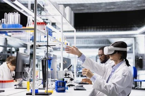 Laboratory chemical engineer using virtual reality tech to process DNA data Stock Photos