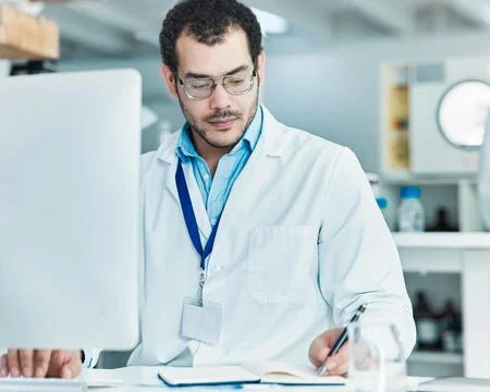 Laboratory, computer and man with notes for research, check information and Stock Photos