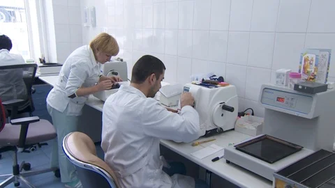 A laboratory employee performs a biopsy. cuts the tumor with a very sharp knife. Stock Footage 113685976