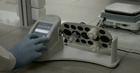 Laboratory equipment. Multi rotator. The hand presses the button Stock Footage 63132943