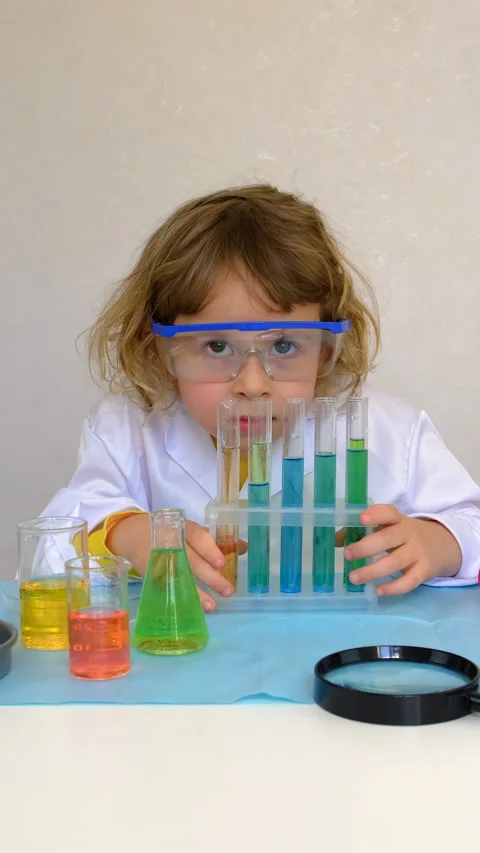 Laboratory examination of a child with test tubes, reagents and a microscope Stock Footage 313336219