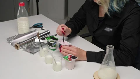 Laboratory Experiment with Milk Samples Stock Footage 306322997