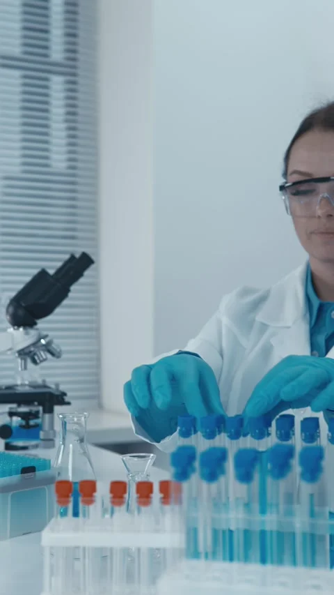 In the laboratory, an experimental geneticist modifies the genomes of organisms Stock Footage 274301788
