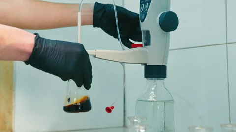 Laboratory Flask Handling by Scientist, Scientist pouring substance from flask Stock Footage 264597435