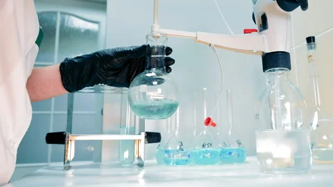 Laboratory Flask in Scientist's Hand, Close-up of a scientist's gloved hand Stock Footage 265490954