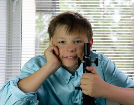 Laboratory. funny boy and microscope. close-up Stock Photos