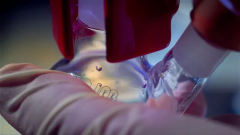 Laboratory glass bottle with a long neck in the hands of a lab technician Stock Footage 257029792