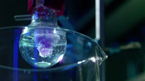 Laboratory glass bottle mixing two chemicals in slow motion Stock Footage 257032711