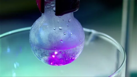 Laboratory glass bottle mixing two chemicals in slow motion Stock Footage 257033862
