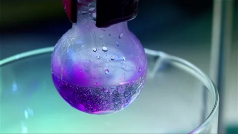 Laboratory glass bottle mixing two chemicals in slow motion Stock Footage 257033974