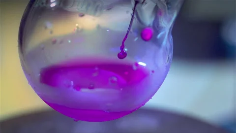 Laboratory glass bottle mixing two chemicals in slow motion Stock Footage 257383191