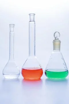 Laboratory glass flasks with multicolored liquid isolated on white Stock Photos
