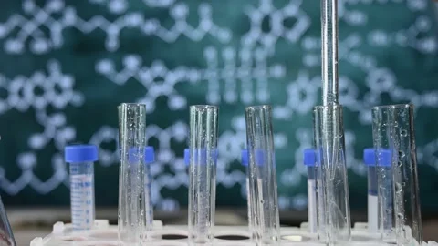 Laboratory glassware with blackboard background with various chemical formulas. Stock Footage 151433093