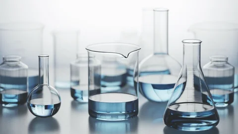 "Laboratory glassware with blue liquid inside on a light background. Looping Video stock 97960741