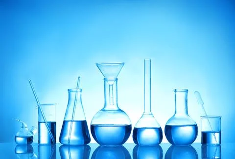 Laboratory glassware with liquid samples for analysis on blue background Stock Photos