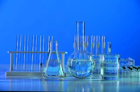 Laboratory Glassware on Reflective Table Stock Photos