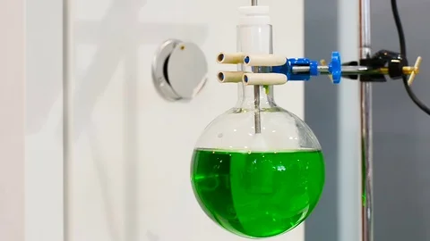 Laboratory glassware on a stirrer Stock Footage 75685729