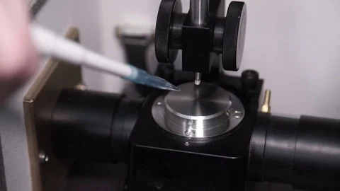In the laboratory hand dripping a drop of liquid on the chromatograph Stock Footage 75316687