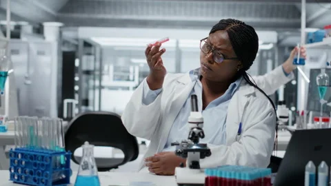 Laboratory histology technician evaluating pharmaceutical compound in petri dish Stock Footage 326013547