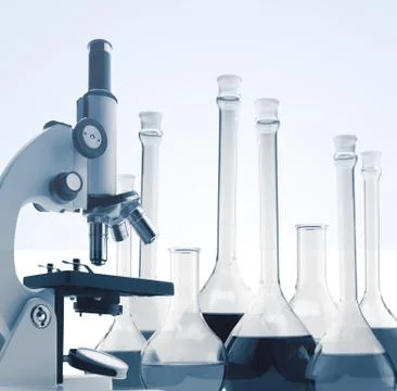 Laboratory metal microscope and test tubes with liquid toning in blue Stockfoto's