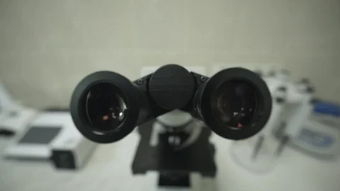 Laboratory microscope is in scientist's office. Medical research of virus and Stockbeeldmateriaal 129489143
