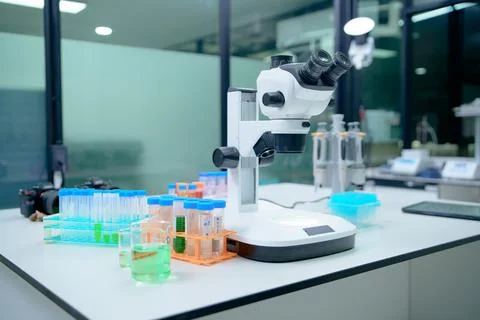 Laboratory Microscope Setup with Test Tubes and Chemical Solutions Stock Photos