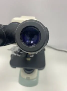 Laboratory microscope viewfinder closeup view with focus on foreground and wh Stock Photos