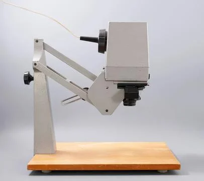 Laboratory microscope on wooden table with gray background Stockfoto's