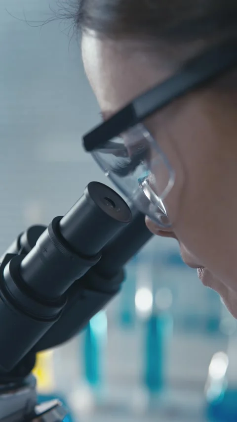 In the laboratory, a molecular biologist studies the structure and function of Stock Footage 266561190