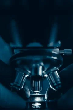 Laboratory optical microscope macro view with gloved hands Stock Photos