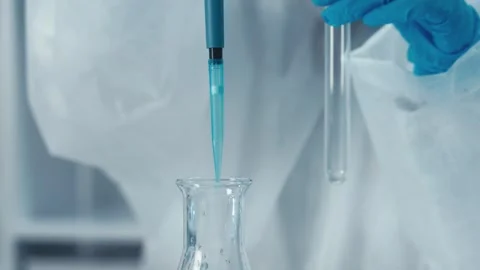 Laboratory Precision Our expert liquid handling with a quality pipette in a Stock Footage 317036012