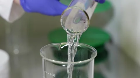 The Laboratory Process Involves Precise Liquid Pouring into a Beaker, Ensuring Stock Footage 304576729