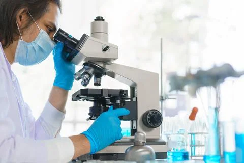 Laboratory research concept, Scientist using microscope to research and devel Stock Photos