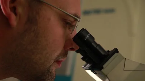 Laboratory researcher working with microscope Stock Footage 41532988