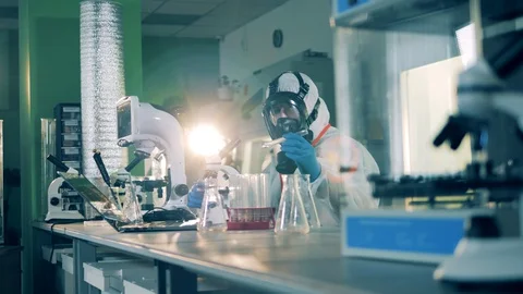 Laboratory researchers develop a covid-19 vaccine. Stock Footage 129573337