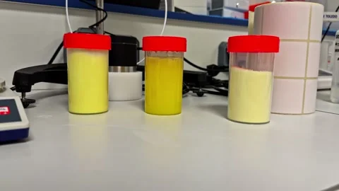 Laboratory Sample Containers Filled With Yellow Powder Stock Footage 341542925
