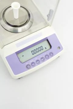Laboratory scale on table in white background Stock Photos