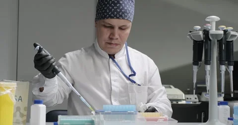 Laboratory scientific experiment. Scientist or chemist drops liquid sample from Stock Footage 266170674