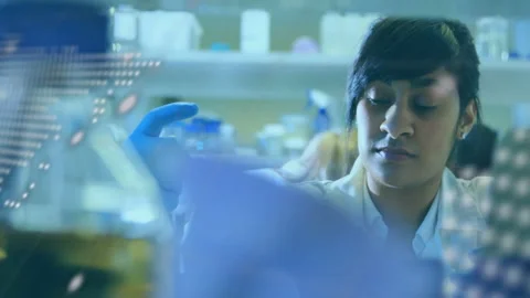 In laboratory, scientist analyzing digital data with world map animation overlay Stock Footage 304856159