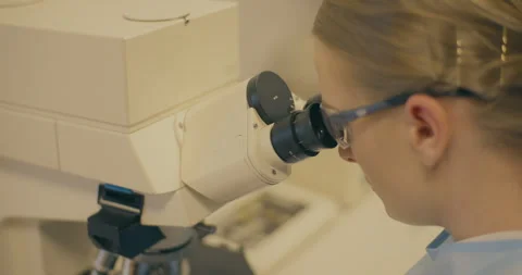 Laboratory Scientist Examining Microscopic Virus Stock Footage 318592826