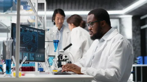 Laboratory scientist squinting eyes at computer monitor, thinking Stock Footage 320145286