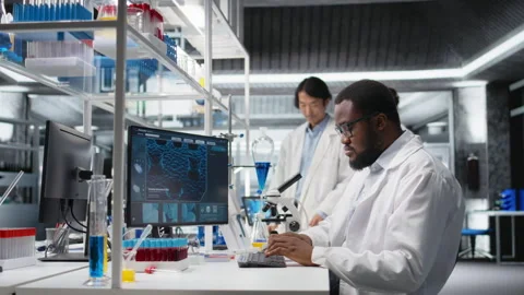 Laboratory scientist squinting eyes at computer monitor, thinking Stock Footage 320146960