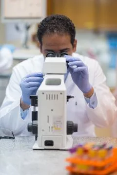 Laboratory scientist using microscope for blood testing and clinical research 스톡 사진