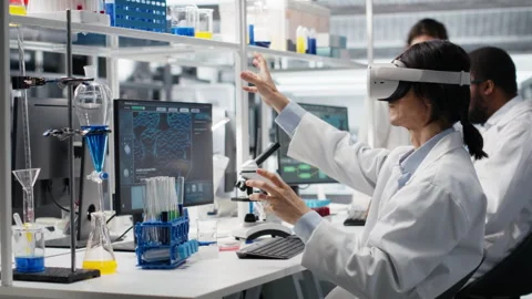 Laboratory scientist using virtual reality tech to process DNA patient data Stock Footage 320147327