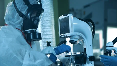 Laboratory specialist is working with a computerized microscope. Medical Stock Footage 129389747