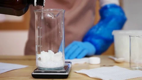 Laboratory stirring white crystals in a flask Stock Footage 76870566
