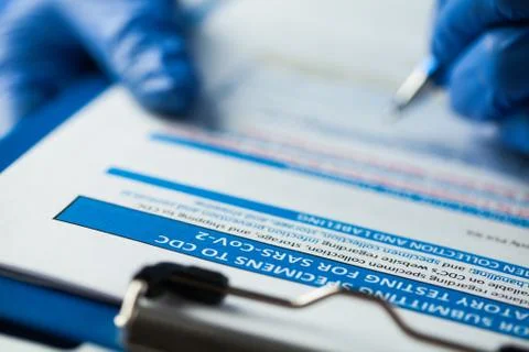 Laboratory technician checking CDC specimen submitting form Stock Photos